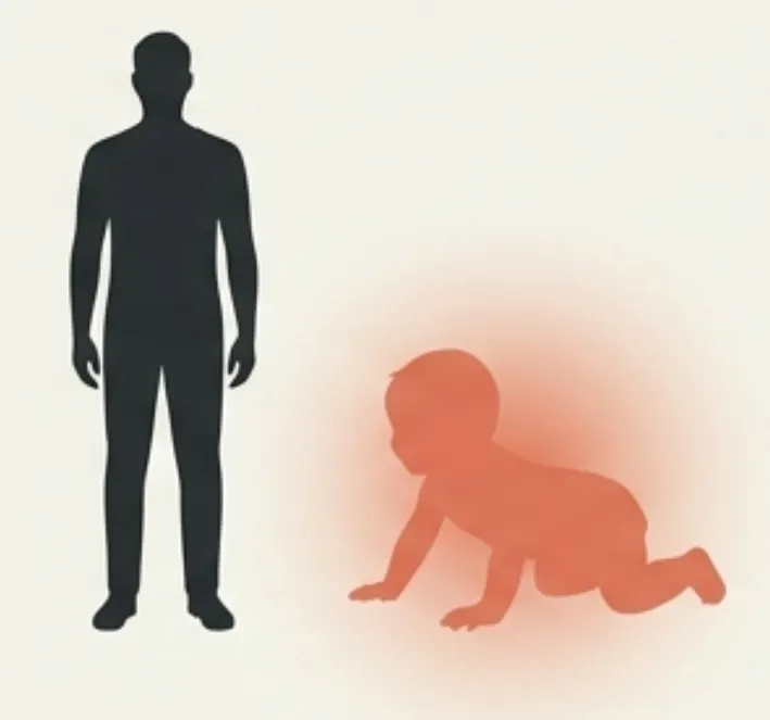 Silhouette of an adult beside a crawling baby
